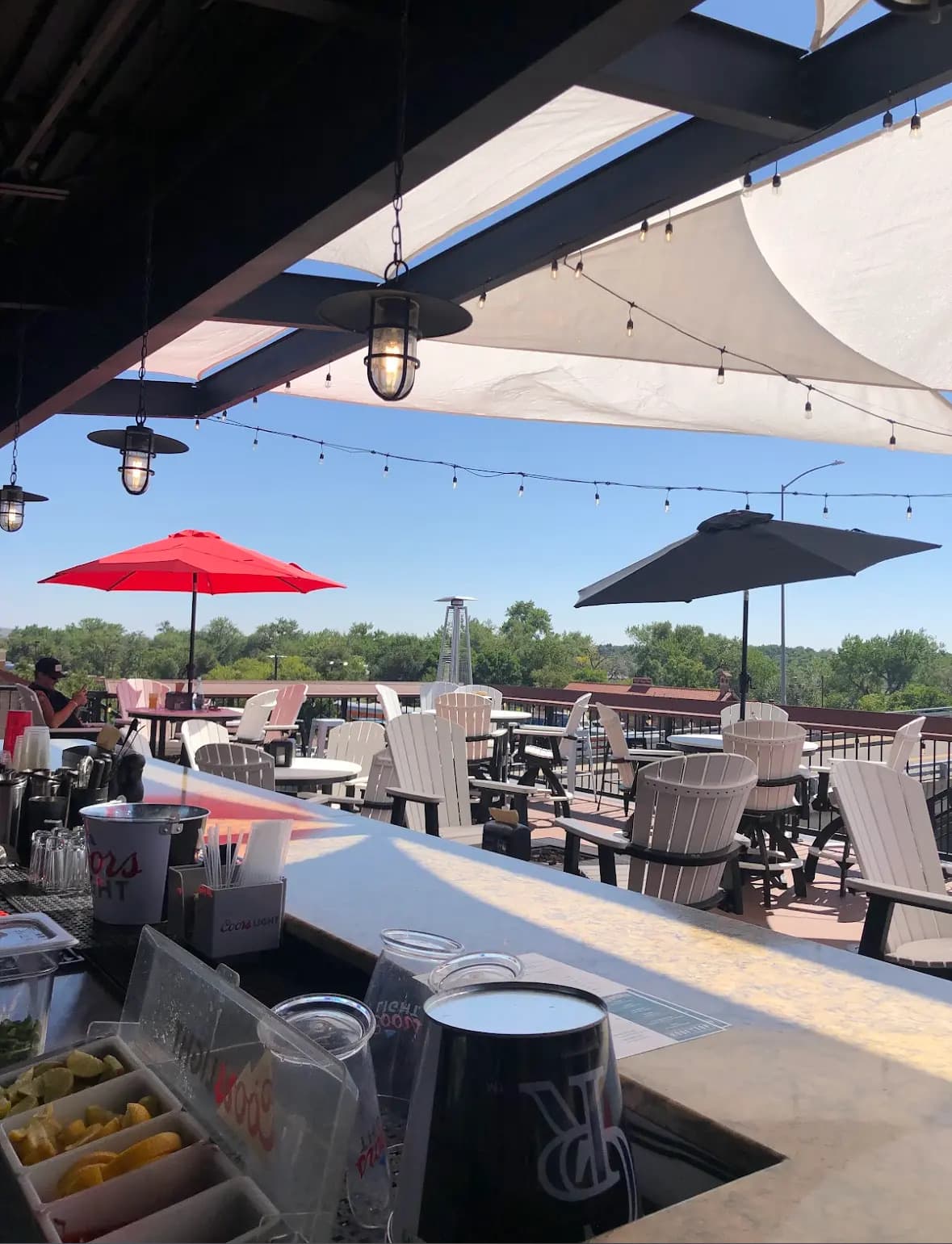 Rooftop patio seating with mountain backdrop at Whitewater Rooftop Social